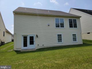 339 Carlisle Dr, Avondale, PA 19311 - rear view of property featuring a lawn and central AC unit