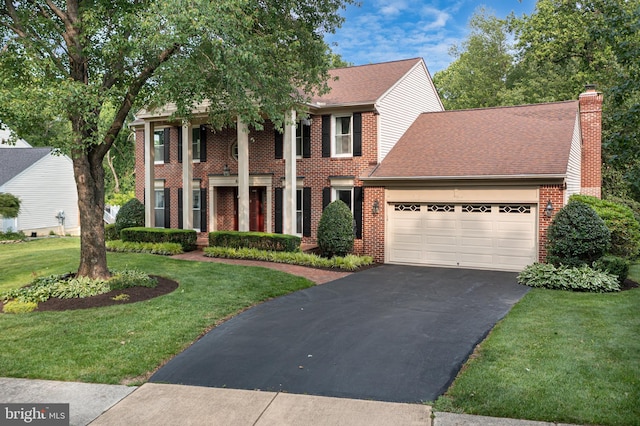 8105 Overlake Ct, Fairfax Station, VA 22039 - greek revival inspired property with asphalt driveway, an attached garage, brick siding, a chimney, and a front yard