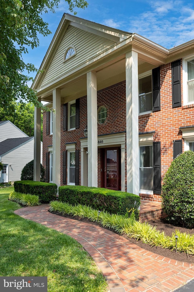 8105 Overlake Ct, Fairfax Station, VA 22039 - neoclassical home featuring brick siding and a front lawn