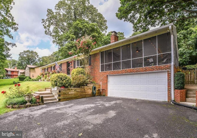 5539 Jefferson Blvd, Frederick, MD 21703 - single story home with asphalt driveway, brick siding, a chimney, and a sunroom