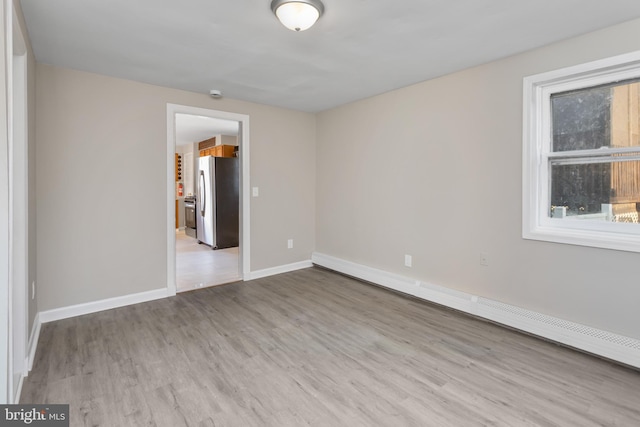 16 Woodside Ln, Keansburg, NJ 07734 - unfurnished room featuring a baseboard radiator, wood finished floors, baseboards, and plenty of natural light