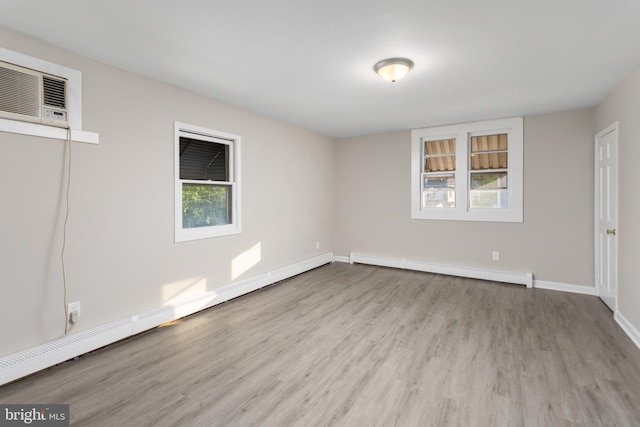 16 Woodside Ln, Keansburg, NJ 07734 - unfurnished room featuring wood finished floors, baseboard heating, baseboards, and a wall mounted air conditioner