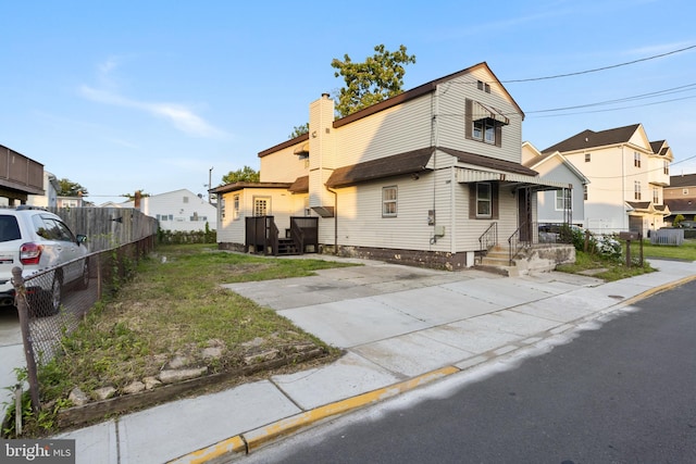 16 Woodside Ln, Keansburg, NJ 07734 - view of front of house featuring a chimney and a residential view