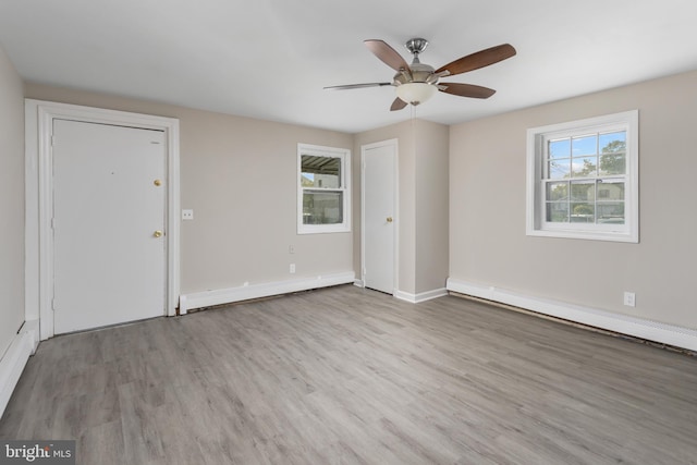 16 Woodside Ln, Keansburg, NJ 07734 - unfurnished room featuring baseboard heating, a ceiling fan, wood finished floors, and baseboards