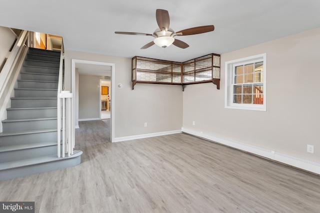 16 Woodside Ln, Keansburg, NJ 07734 - unfurnished living room with ceiling fan, a baseboard radiator, wood finished floors, stairway, and baseboards