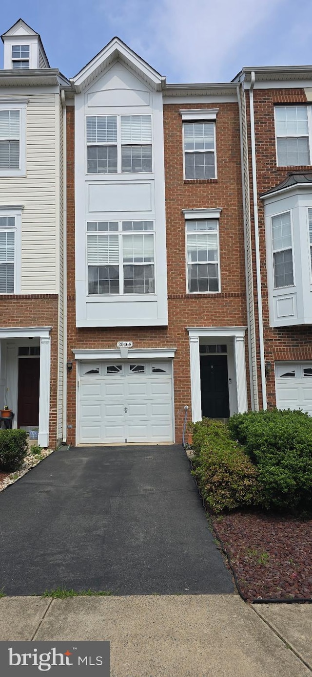 20468 Alicent Ter, Ashburn, VA 20147 - townhome / multi-family property featuring asphalt driveway, an attached garage, and brick siding