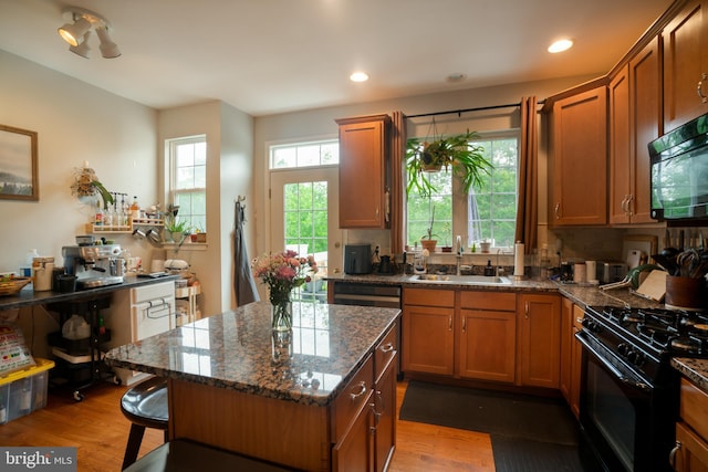20468 Alicent Ter, Ashburn, VA 20147 - kitchen featuring black appliances, wood finished floors, brown cabinets, and recessed lighting