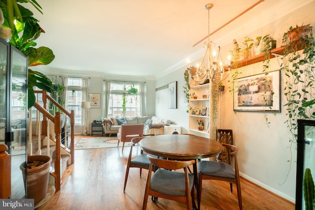 20468 Alicent Ter, Ashburn, VA 20147 - dining space featuring crown molding, stairs, wood finished floors, and a chandelier