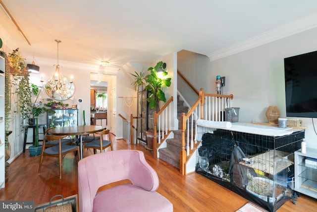 20468 Alicent Ter, Ashburn, VA 20147 - living area featuring ornamental molding, stairway, a chandelier, and wood finished floors