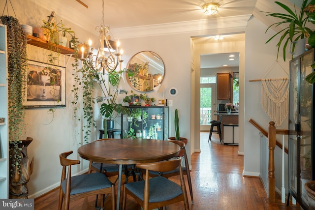20468 Alicent Ter, Ashburn, VA 20147 - dining area with wood finished floors, ornamental molding, and a chandelier
