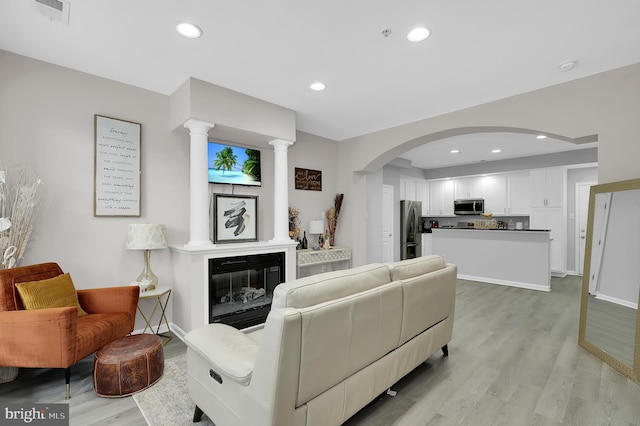 1813 Wheyfield Dr Unit 10-A, Frederick, MD 21701 - living area with light wood finished floors, arched walkways, and recessed lighting