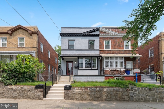 713 Tewkesbury Pl NW, Washington, DC 20012 - view of front facade featuring covered porch and brick siding