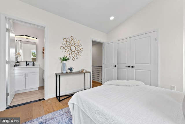 713 Tewkesbury Pl NW, Washington, DC 20012 - bedroom featuring a sink, light wood-style floors, lofted ceiling, recessed lighting, and a closet