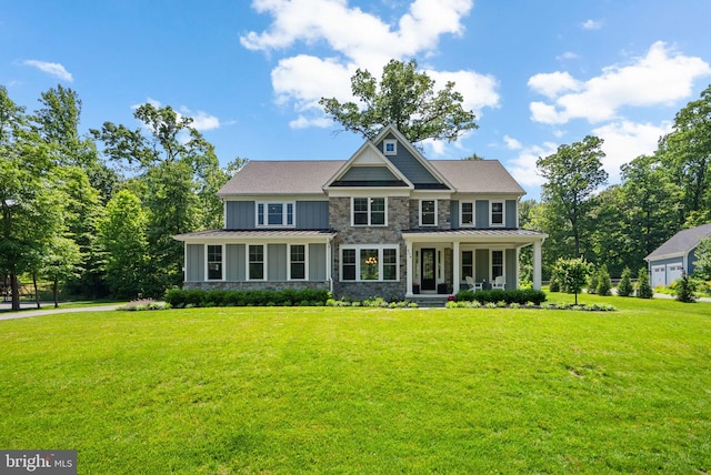 904 Misty Manor Ln, Millersville, MD 21108 - view of front of property featuring a standing seam roof, a porch, stone siding, and a front yard