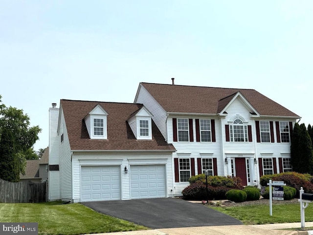 13225 Scottish Hunt Ln, Bristow, VA 20136 - colonial house featuring driveway, a chimney, a garage, and roof with shingles