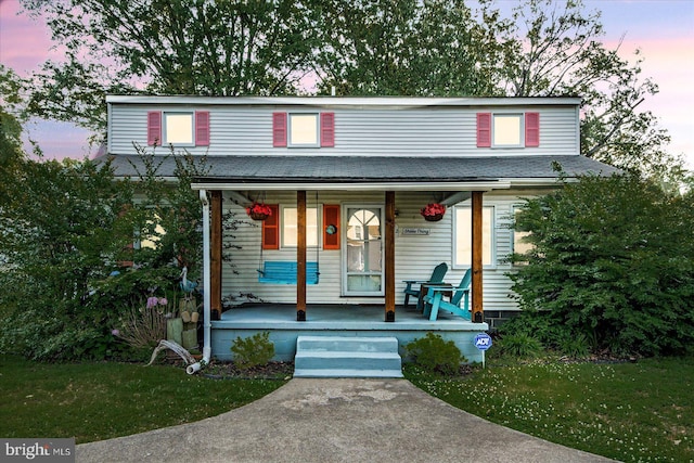 412 Marshall Ave, Colonial Beach, VA 22443 - view of front of home featuring a porch, a yard, and a shingled roof