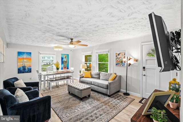 412 Marshall Ave, Colonial Beach, VA 22443 - living area with light wood-style floors, ceiling fan, baseboards, and a textured ceiling