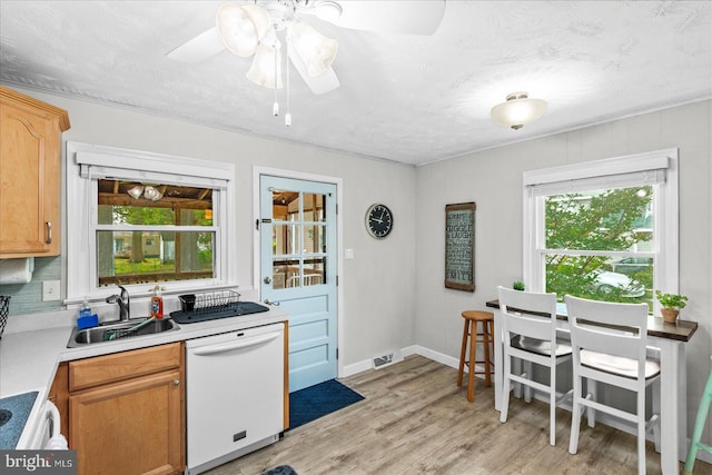 412 Marshall Ave, Colonial Beach, VA 22443 - kitchen with dishwasher, a sink, healthy amount of natural light, light countertops, and a textured ceiling
