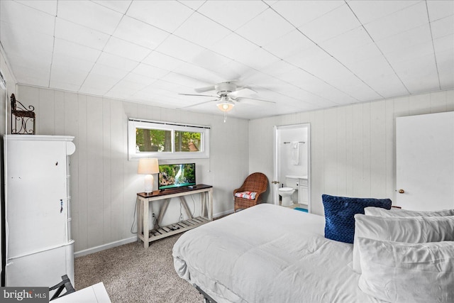 412 Marshall Ave, Colonial Beach, VA 22443 - bedroom featuring carpet floors, baseboards, ceiling fan, wood walls, and connected bathroom