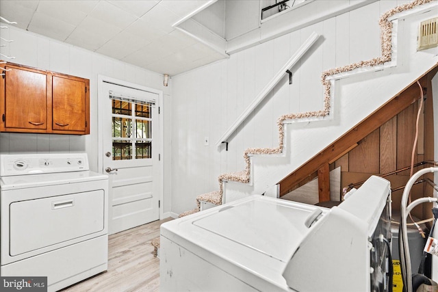 412 Marshall Ave, Colonial Beach, VA 22443 - laundry room featuring independent washer and dryer, light wood-style floors, and cabinet space