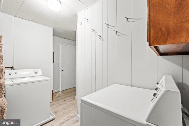 412 Marshall Ave, Colonial Beach, VA 22443 - laundry area with cabinet space, light wood-type flooring, and washer and dryer