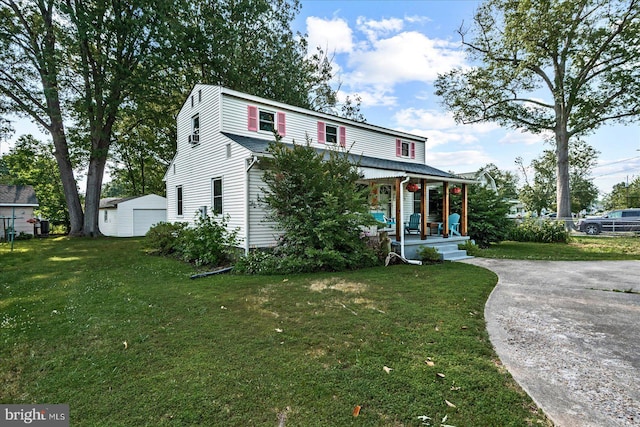 412 Marshall Ave, Colonial Beach, VA 22443 - view of front facade with a porch, a front yard, and a detached garage
