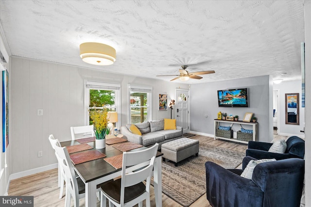 412 Marshall Ave, Colonial Beach, VA 22443 - living room with light wood-type flooring, a textured ceiling, baseboards, and a ceiling fan