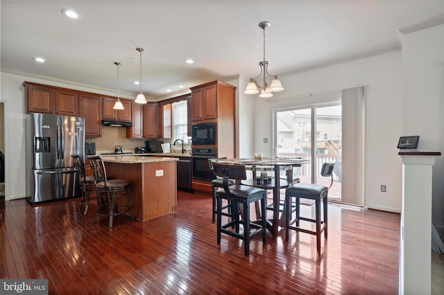 2652 Academic Ct, Waldorf, MD 20603 - kitchen featuring black appliances, a kitchen island, ornamental molding, a chandelier, and backsplash