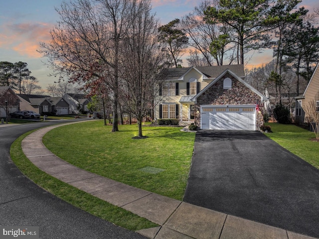 32645 Seaview Loop, Millsboro, DE 19966 - traditional-style home featuring stone siding, driveway, a front lawn, and a garage