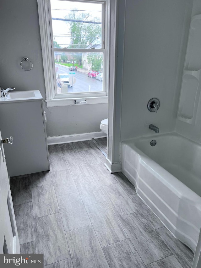 163 N W St, Carlisle, PA 17013 - full bath with vanity, healthy amount of natural light, toilet, and baseboards