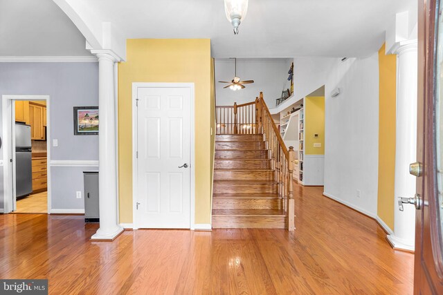 240 Charleston Rd, Ocean Pines, MD 21811 - foyer featuring decorative columns, a ceiling fan, light wood-style flooring, and stairs