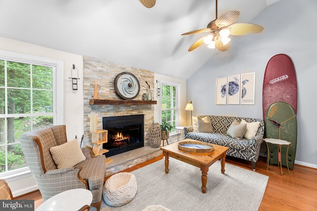240 Charleston Rd, Ocean Pines, MD 21811 - living area featuring lofted ceiling, a stone fireplace, wood finished floors, and a ceiling fan