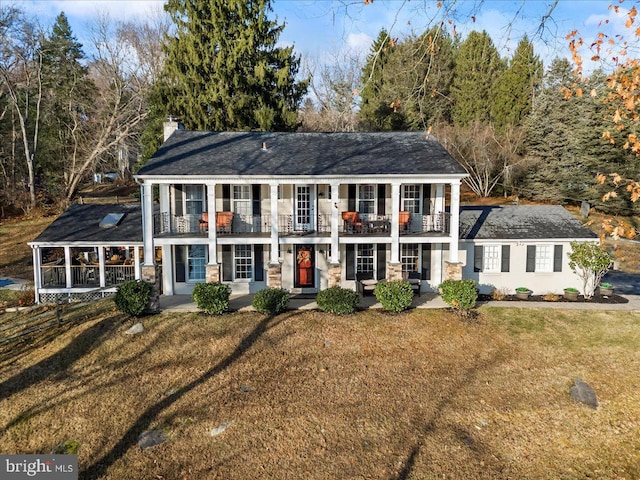 601 Crum Creek Rd, Media, PA 19063 - greek revival inspired property with a balcony, a front lawn, a chimney, and covered porch