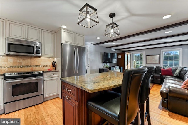 601 Crum Creek Rd, Media, PA 19063 - kitchen featuring stainless steel appliances, open floor plan, recessed lighting, light stone counters, and light wood-style flooring