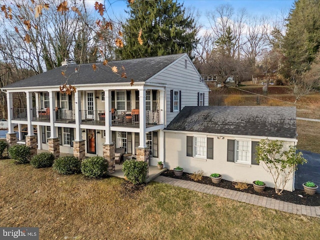 601 Crum Creek Rd, Media, PA 19063 - view of front of property with a balcony, a front lawn, a chimney, roof with shingles, and a patio