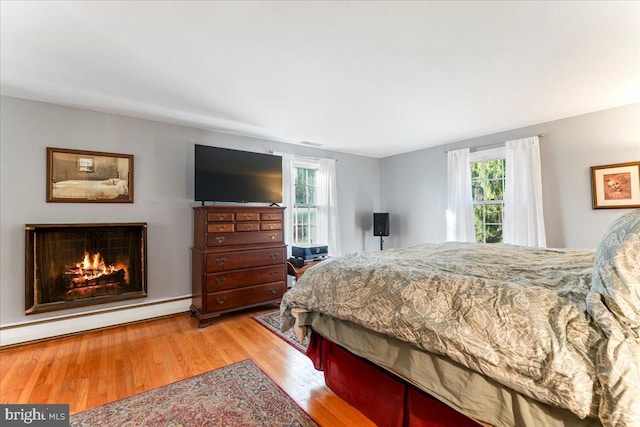 601 Crum Creek Rd, Media, PA 19063 - bedroom featuring a lit fireplace and wood finished floors