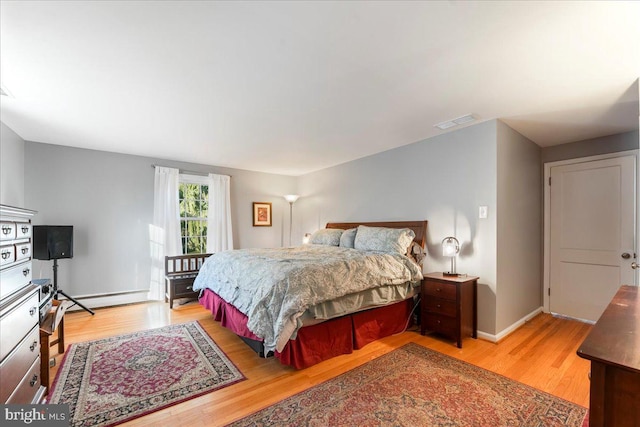 601 Crum Creek Rd, Media, PA 19063 - bedroom with a baseboard radiator, light wood finished floors, and baseboards