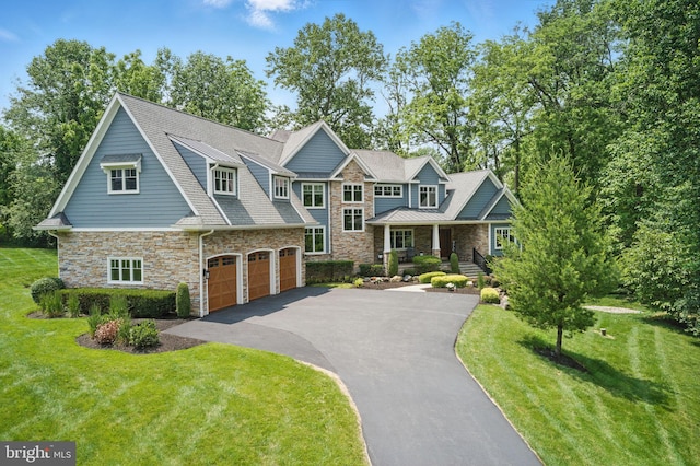 415 Pyles Mountain Ln, Avondale, PA 19311 - view of front of house featuring stone siding, a garage, driveway, and a front lawn