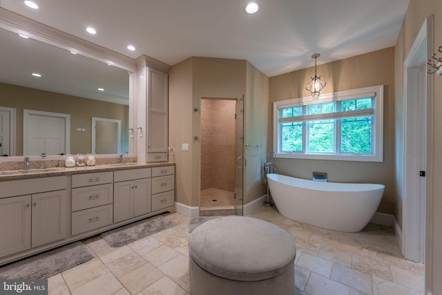 415 Pyles Mountain Ln, Avondale, PA 19311 - bathroom with double vanity, a stall shower, a freestanding tub, stone tile floors, and recessed lighting