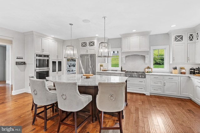 415 Pyles Mountain Ln, Avondale, PA 19311 - kitchen featuring appliances with stainless steel finishes, backsplash, light wood finished floors, a kitchen island, and recessed lighting