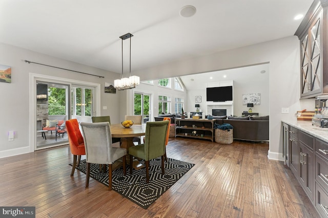 415 Pyles Mountain Ln, Avondale, PA 19311 - dining space with a fireplace, dark wood-style flooring, and a chandelier