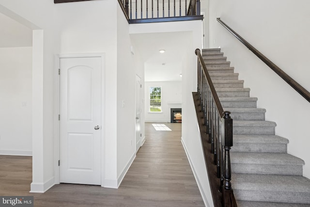87 Eagle Ln Unit 5, Hanover, PA 17331 - stairs with wood finished floors and a warm lit fireplace