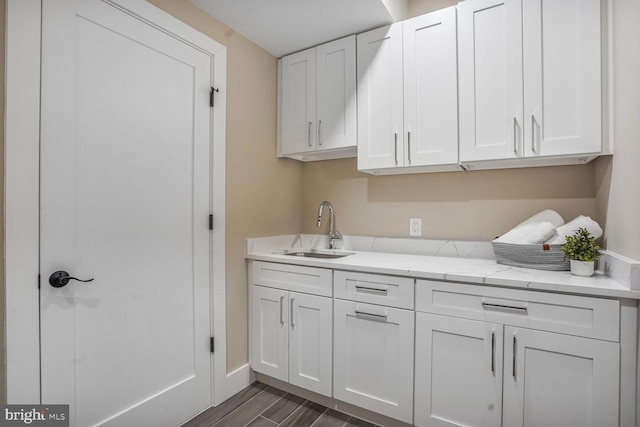 504 Kingsley Rd SW, Vienna, VA 22180 - kitchen featuring white cabinets, light stone counters, and dark wood-style floors