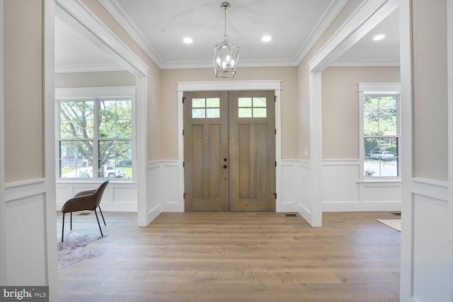 504 Kingsley Rd SW, Vienna, VA 22180 - entryway with a chandelier, crown molding, wood finished floors, wainscoting, and recessed lighting