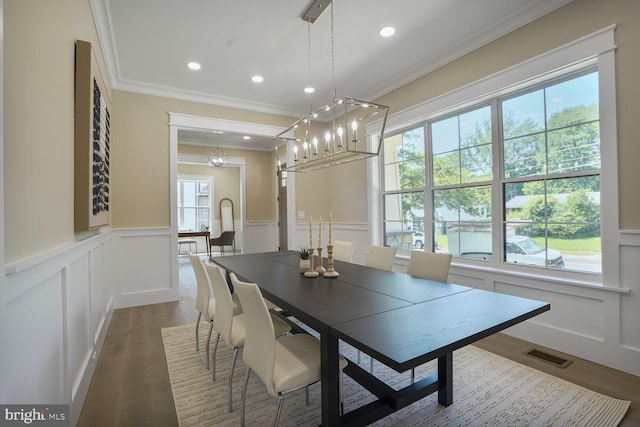 504 Kingsley Rd SW, Vienna, VA 22180 - dining space with crown molding, a decorative wall, a chandelier, a wainscoted wall, and dark wood-style floors