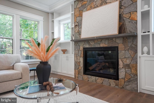 504 Kingsley Rd SW, Vienna, VA 22180 - living area featuring wood finished floors, ornamental molding, healthy amount of natural light, and a fireplace