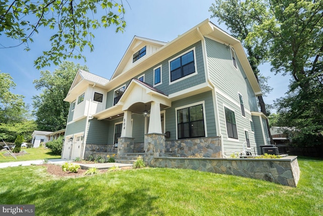 504 Kingsley Rd SW, Vienna, VA 22180 - view of front of property featuring an attached garage, a porch, stone siding, and a front yard