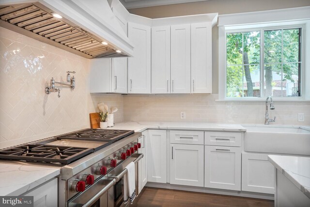 504 Kingsley Rd SW, Vienna, VA 22180 - kitchen featuring stainless steel range, premium range hood, white cabinetry, decorative backsplash, and light stone countertops