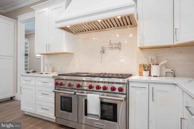 504 Kingsley Rd SW, Vienna, VA 22180 - kitchen with double oven range, premium range hood, crown molding, white cabinetry, and backsplash