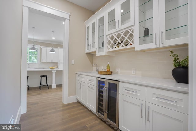 504 Kingsley Rd SW, Vienna, VA 22180 - indoor bar with wine cooler, dark wood-type flooring, backsplash, and ornamental molding